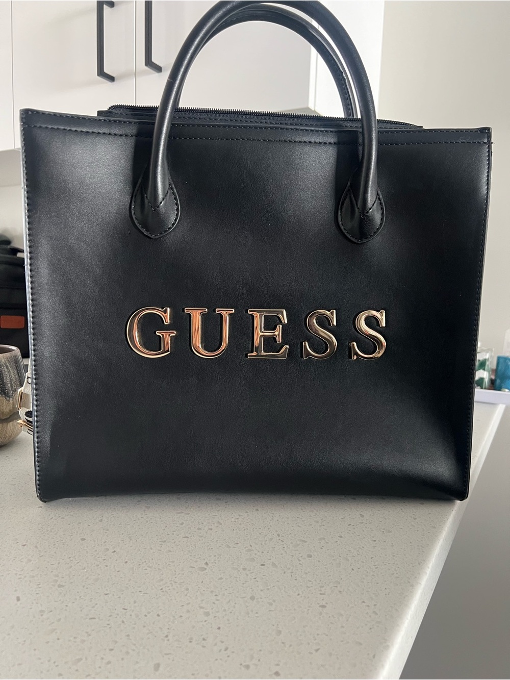 GUESS Black Satchel with Gold Logo Accents, perfect for a laptop bag.